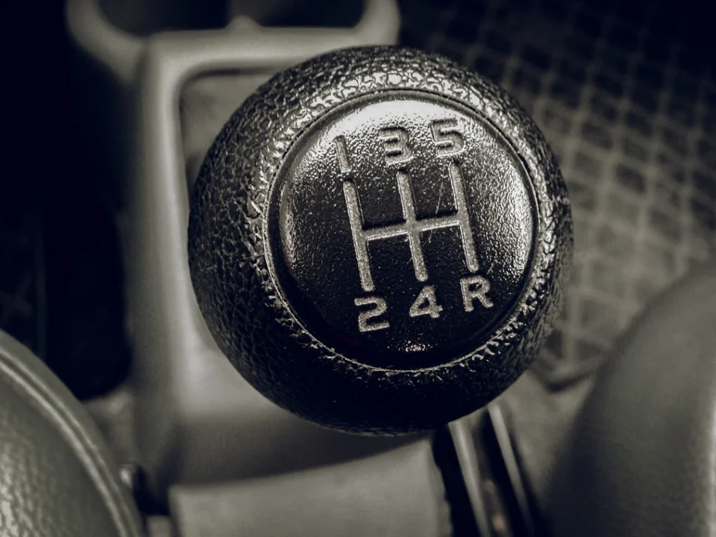 Close-up of a manual car gear stick, representing a driver upgrading from an automatic to a manual licence in Manchester