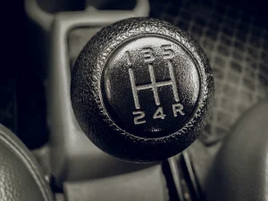 Close-up of a manual car gear stick, representing a driver upgrading from an automatic to a manual licence in Manchester